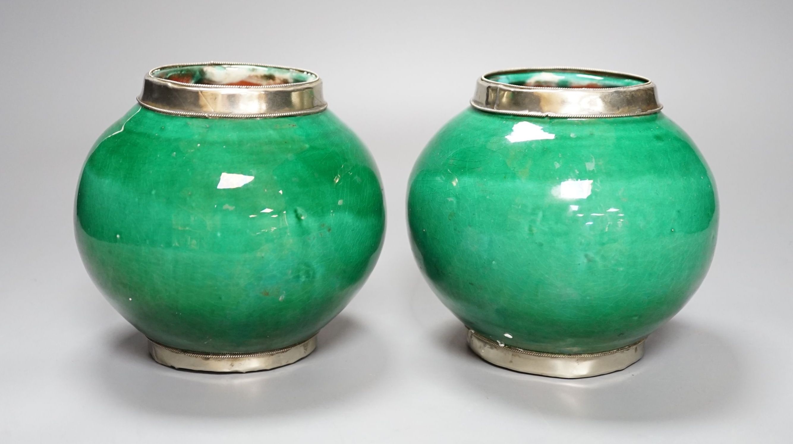 A pair of Tibetan green glazed vases - 14cm high